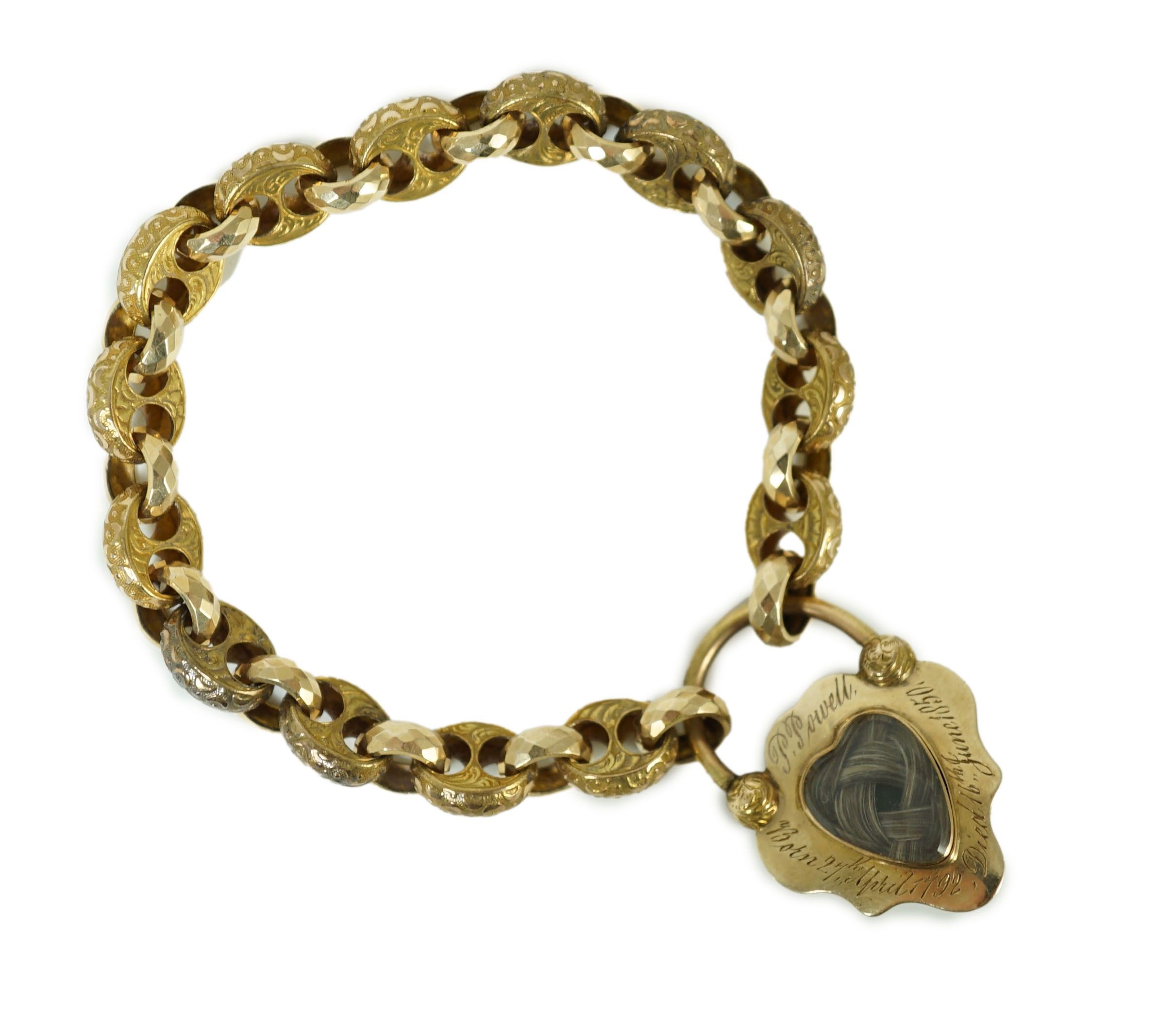 A Victorian engraved and facetted link gold mourning bracelet, with pear shaped foil backed? garnet set heart shape padlock